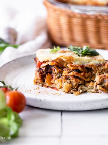 This is the BEST Vegan Lasagna! It's layered with vegan almond ricotta, mushroom tempeh marinara sauce, and topped with a simple vegan mozzarella cheese that bubbles and browns. It's easy to make gluten-free as well!