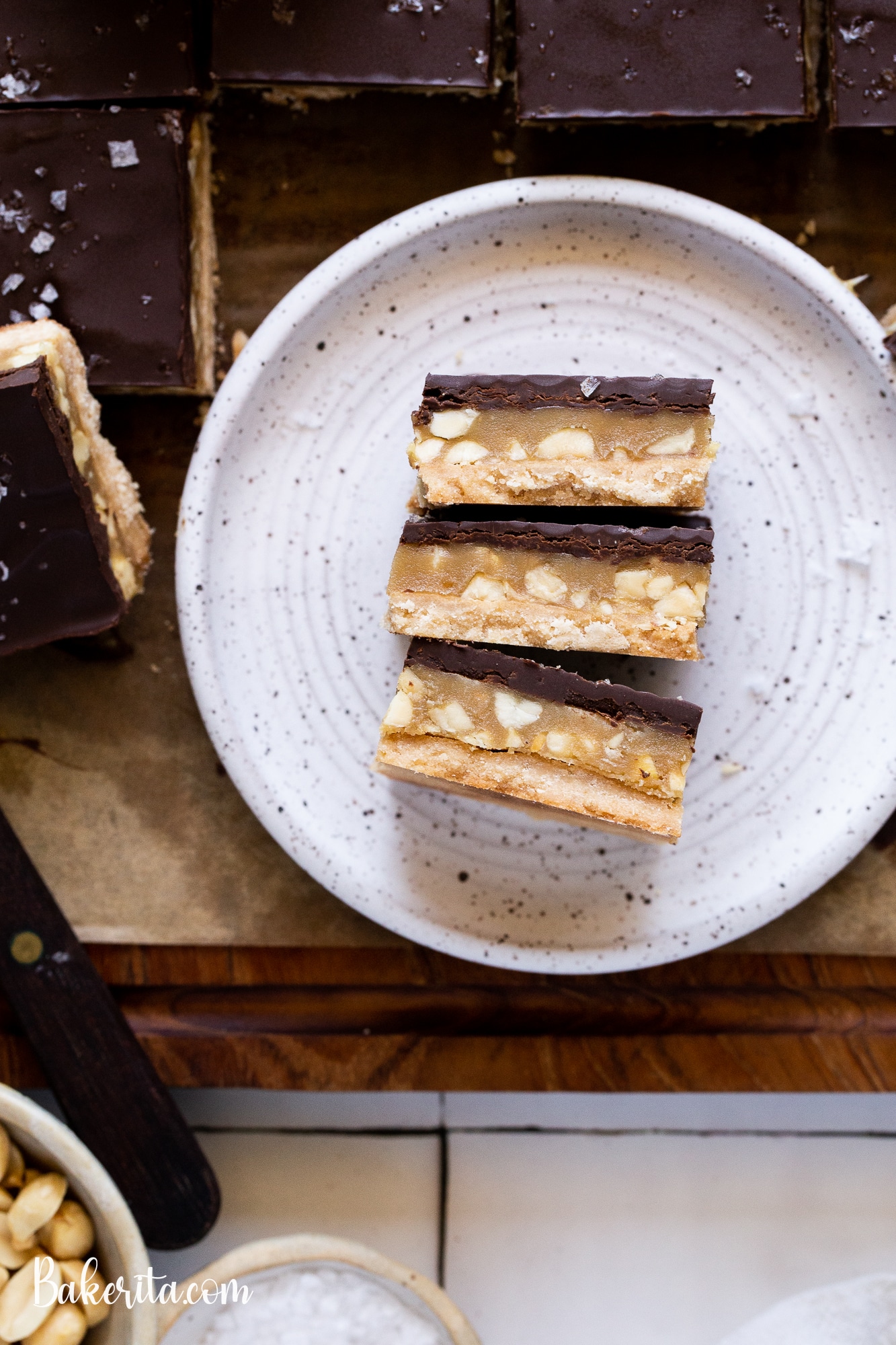 Calling all peanut butter lovers! These Gluten-Free Vegan Peanut Butter Millionaire's Shortbread will knock your socks off. They have a layer of coconut flour shortbread, a quick no-cook peanut butter caramel, and a layer of dark chocolate.