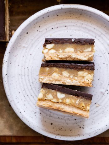 Calling all peanut butter lovers! These Gluten-Free Vegan Peanut Butter Twix Bars will knock your socks off. They have a layer of coconut flour shortbread, a quick no-cook peanut butter caramel, and a layer of dark chocolate.