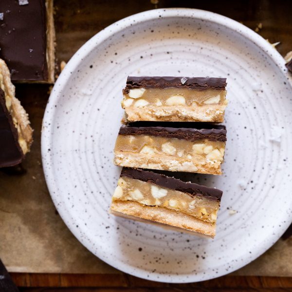 Calling all peanut butter lovers! These Gluten-Free Vegan Peanut Butter Twix Bars will knock your socks off. They have a layer of coconut flour shortbread, a quick no-cook peanut butter caramel, and a layer of dark chocolate.