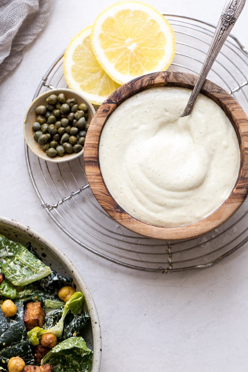 We make this creamy Vegan Caesar Dressing without any dairy, yet it maintains the creaminess you love from a classic Caesar dressing thanks to soaked cashews. The dressing is briny, salty, tart, and so delicious as a salad dressing, a dip, or spread on sandwiches and wraps.