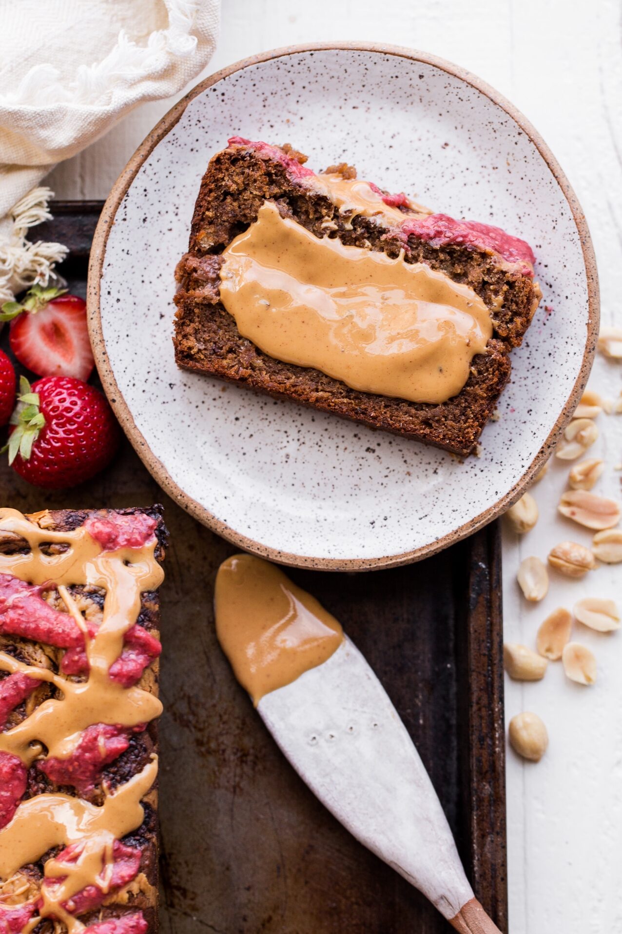 This Peanut Butter & Jelly Banana Bread will remind you of a PB&J sandwich, but in soft & sweet banana bread form. This recipe is gluten-free, vegan, and layered with homemade strawberry chia jam and creamy peanut butter.